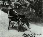 Cassatt seated in a chair with an umbrella. Verso reads 'The only photograph for which she ever posed. Courtesy of Durand-Ruel.'